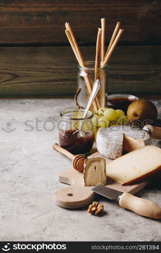 White wine with charcuterie assortment on the stone background. Wine and snack set