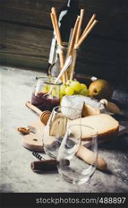 White wine with charcuterie assortment on the stone background. Wine and snack set