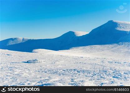 White winter mountains in snow. Natural landscape with hills