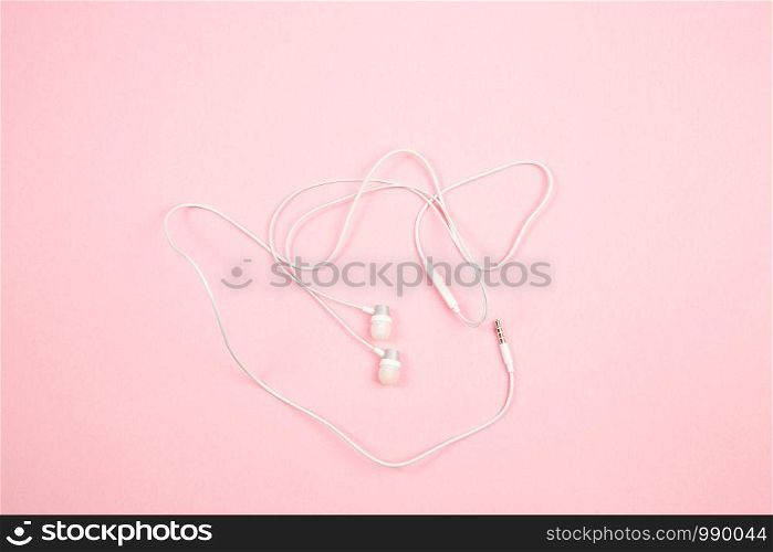white wired headphones on pink isolated background. top view. flat lay. mockup
