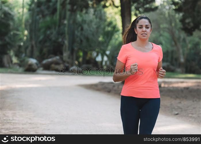 white woman smiling running through the park