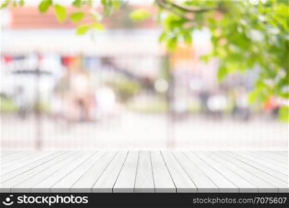 white wood table top on blurred background from garden, Space for montage your product