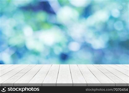 white wood table top on nature blue blurred background for montage your product