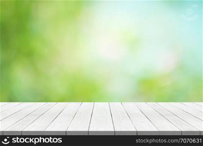 white wood table top on nature green blurred background for montage your product