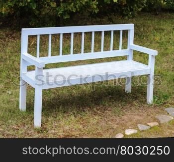 White wooden bench in old suburban autumn park
