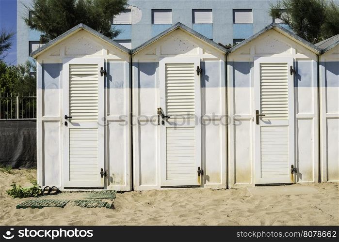White wooden cabins on the beach.