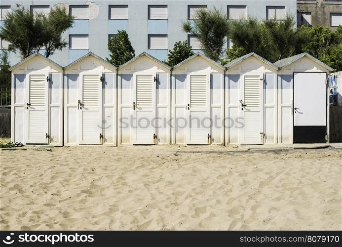 White wooden cabins on the beach.