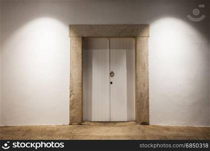 White wooden door over white old wall