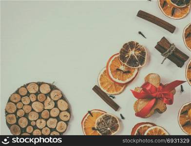 white wooden festive background with slices of dried fruits and gingerbread, vintage toning