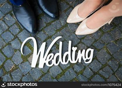 white wooden sign at the wedding is the couple of feet. white wooden sign at wedding is the couple of feet