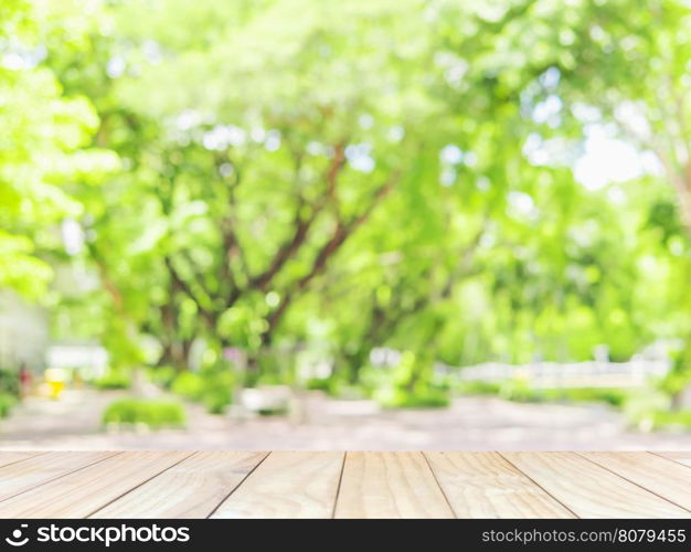 White wooden terrace with blurred green tree background with white bokeh in the campus