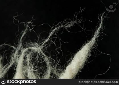 White wool fibers closeup. Black isolated