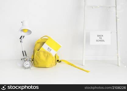 white workplace pupil with yellow bag alarm clock