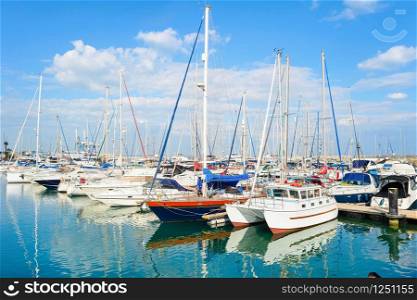 White yachts and motorboats moored in Larnaca marina on sunny day, Cyprus