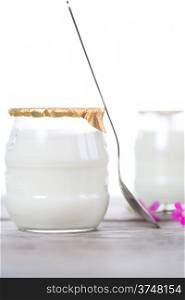 White yogurt in a glass bowl on white background
