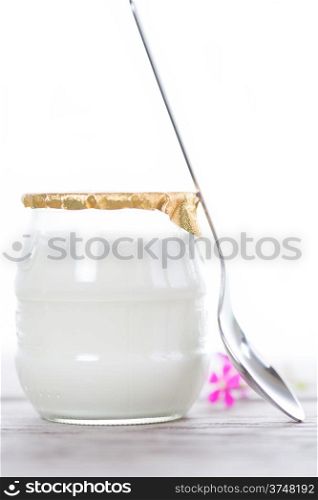 White yogurt in a glass bowl on white background