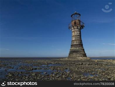 Whiteford Lighthouse is the only wave swept cast iron lighthouse in Britain. See here at low tide. Whiteford Point, Whiteford Sands, Gower Peninsular, South Wales, United Kingdom, Europe.