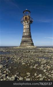 Whiteford Lighthouse is the only wave swept cast iron lighthouse in Britain. See here at low tide. Whiteford Point, Whiteford Sands, Gower Peninsular, South Wales, United Kingdom, Europe.