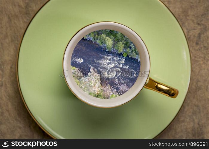 Whitewater coffee dream - landscape of a mountain river inside expresso coffee cup.