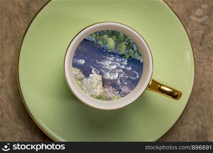 Whitewater coffee dream - landscape of a mountain river inside expresso coffee cup.