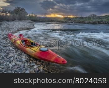 whitewater kayak and river rapid at sunset - Cache la Poudre River in Fort Collins, Colorado