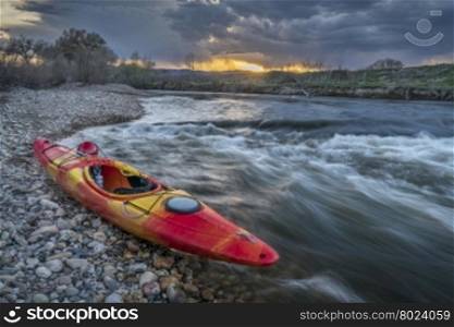 whitewater kayak and river rapid at sunset - Cache la Poudre River in Fort Collins, Colorado