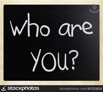 ""Who are you" handwritten with white chalk on a blackboard"