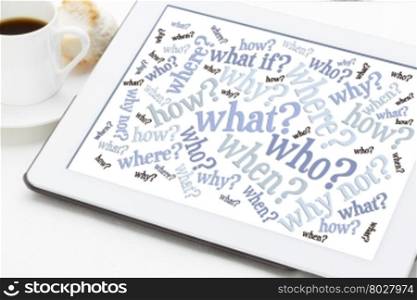 who, what, when, where, why, how questions - brainstorming concept - word cloud on a tablet with a cup of coffee