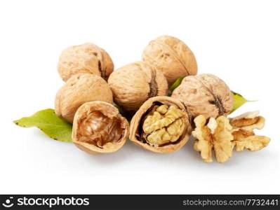 Whole and cracked walnuts on a white background. Half of walnut, green leaves and shell
