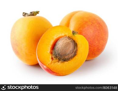 Whole and cut apricots with stones isolated on white background. Whole and cut apricots with stones
