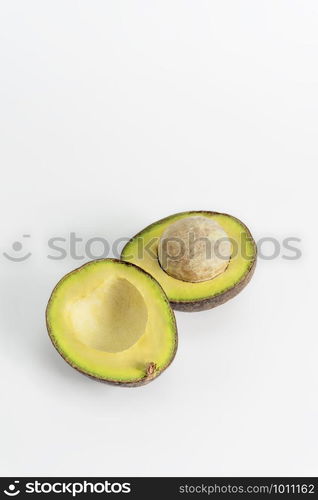 Whole and cut in half avocado fruit on white background. avocado fruit on white