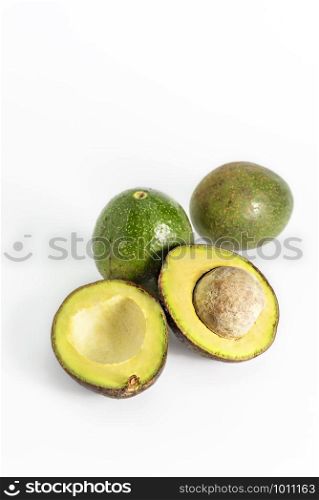 Whole and cut in half avocado fruit on white background. avocado fruit on white