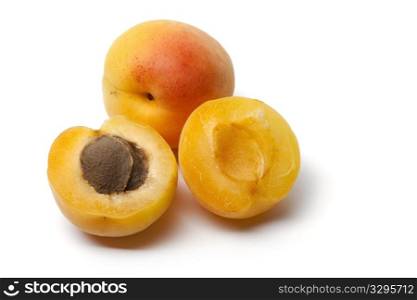 Whole and half apricot isolated on white background