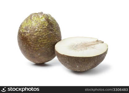 Whole and half breadfruit on white background