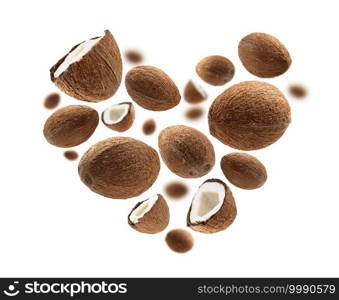 Whole and half cocoanuts in the shape of a heart on a white background.. Whole and half cocoanuts in the shape of a heart on a white background