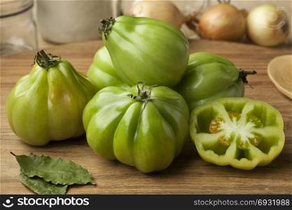 Whole and half fresh green Coeur de boeuf tomatoes