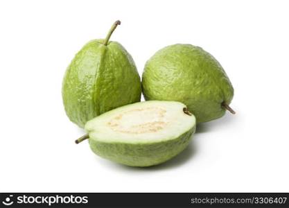Whole and half fresh guava on white background