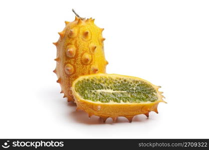 Whole and half fresh kiwano fruit on white background