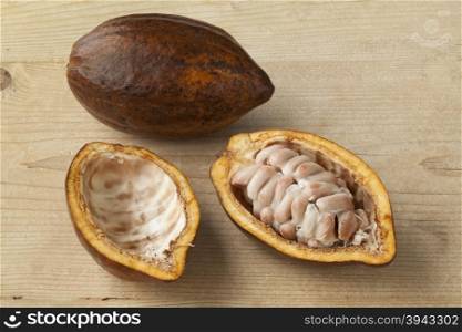 Whole and half fresh ripe cacao fruit and seeds