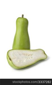 Whole and half green bottle gourd on white background