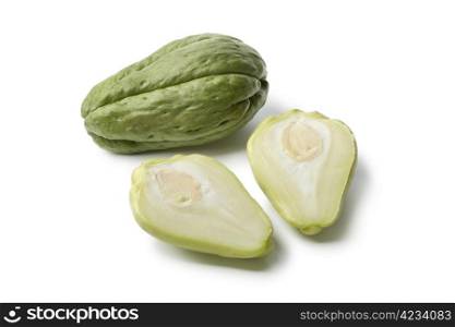 Whole and partial chayote on white background