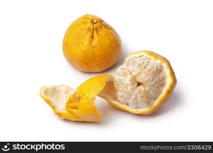 Whole and partial peeled ugli fruit isolated on white background