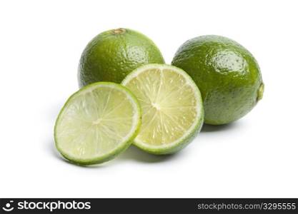 Whole and sectioned limes isolated on white background