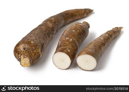 Whole Cassava root and two parts isolated at white background