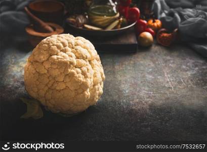 Whole cauliflower lie on dark rustic kitchen table background. Copy space