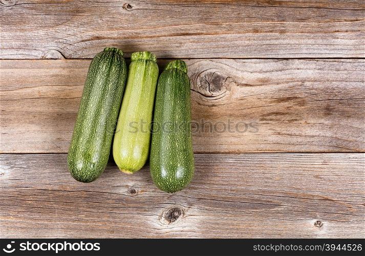 Whole cucumbers on vintage wood. High angled view.
