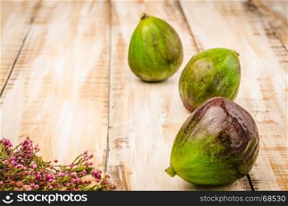 Whole figs on top of a rustic wooden table
