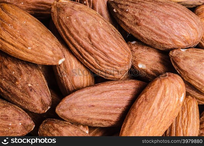 Whole food good for health. Peeled almonds closeup as background texture