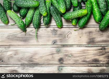Whole fresh cucumbers. On wooden background. Whole fresh cucumbers.