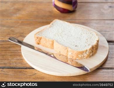 Whole grain bread on wooden plate, stock photo